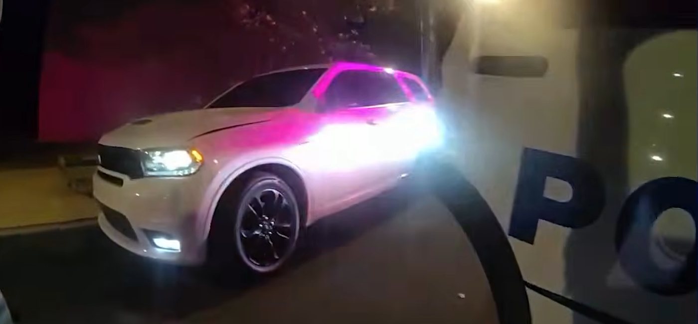 Phillip Brown's white Dodge Durango stopped on Benning Road NE at night, lit by police emergency lights, seen from a Metropolitan Police Department body-worn camera.